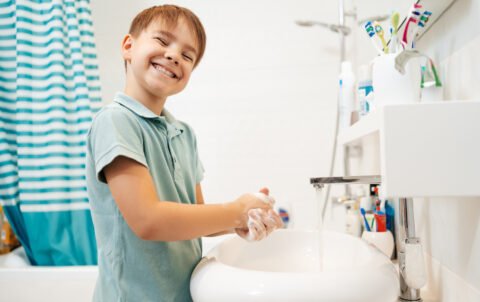 preschool-smiling-boy-washing-hands-with-soap-faucet-with-water